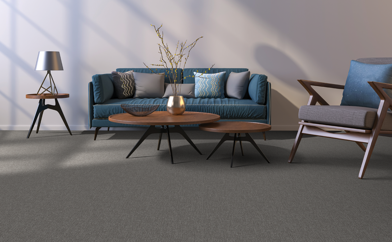 dark gray black carpet in living area with blue sofa and coffee tables